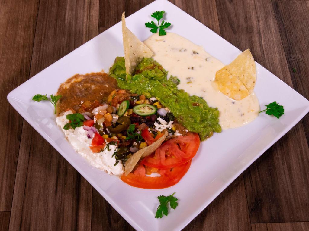 Appetizer Trio · Homemade guacamole, 7 layer dip and white queso served with chips. 