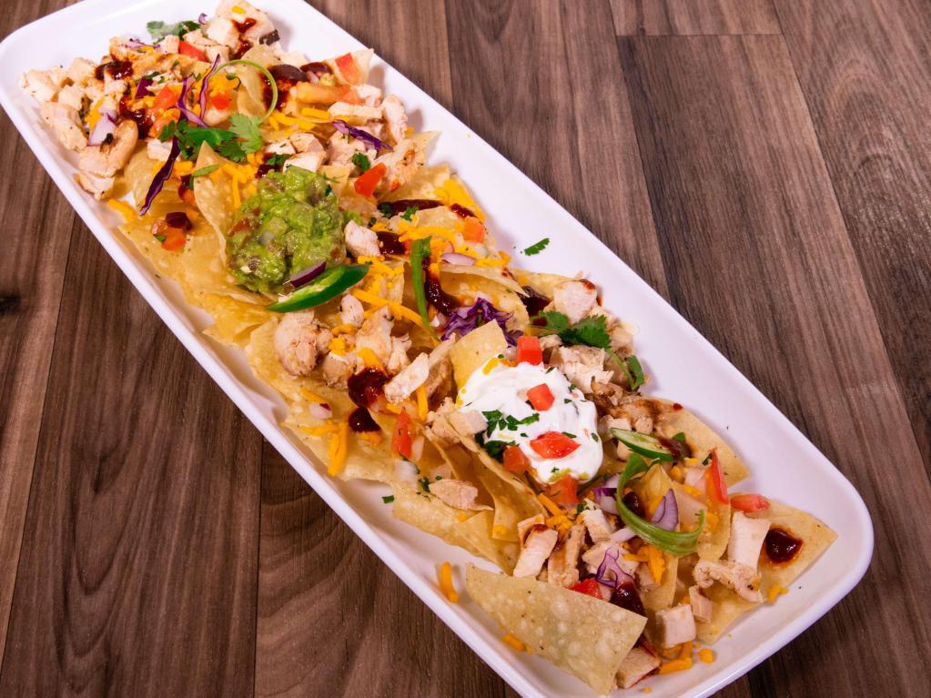 Nachos · Chips piled high with refried beans, cheese and your choice of Beef Fajita, Chicken Fajita or Picadillo. We add sour cream, guacamole and our signature sweet habanero sauce.