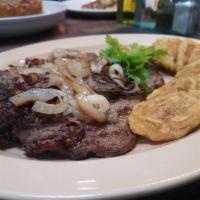 Bistec Encebollado · Steak with onions. Served with rice and beans or green or yellow plantains or french fries o...
