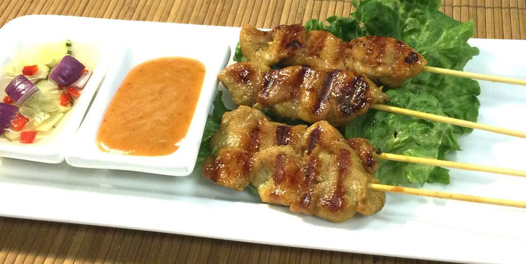A5. Satay · Strips of grilled marinated chicken on bamboo skewers / peanut sauce / cucumber sauce
