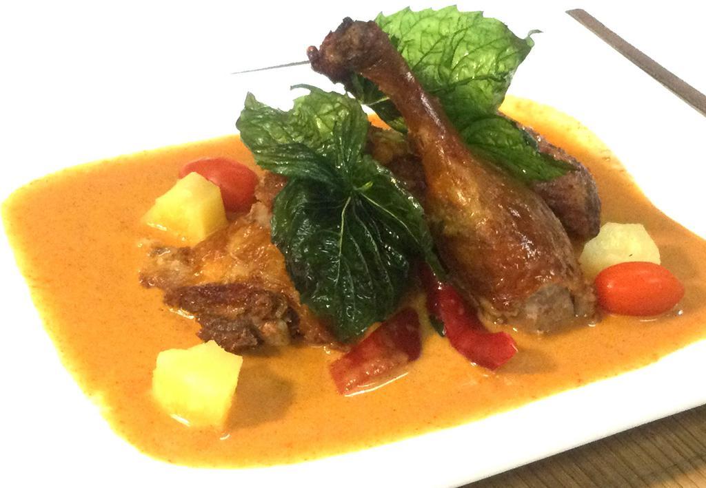 D2. Duck Curry · Half duck in red curry / coconut milk / tomato / pineapple / bell pepper / basil leaves
