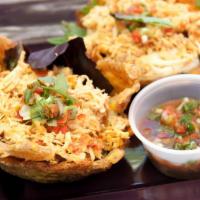 Chicken Patacon · 2 Savory fried plantain cups with our seasoned shredded chicken, mozzarella cheese, mixed gr...