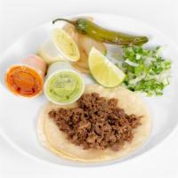 Tacos · corn or flour tortilla with cilantro and onions, grill onions, jalapeño, and lime on a side.