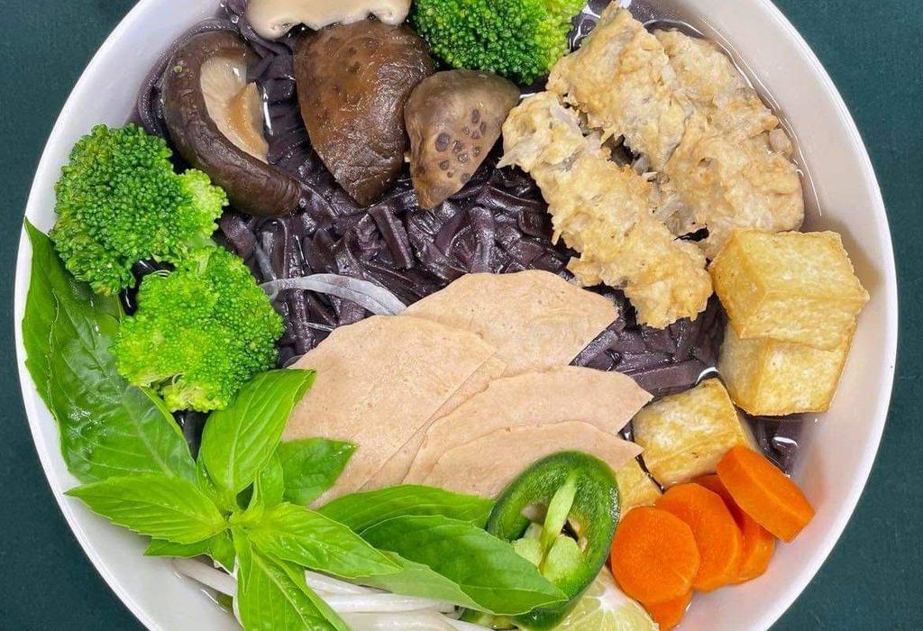41A. Black Rice Vegetable Pho · Freshly made noodles from black rice with tops of shiitake mushroom, tofu, veggie ham, gobo tempura, carrot, and broccoli.