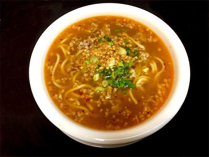 Spicy Noodle Soup · Egg noodles with minced pork in a spicy, sweet and tangy pork broth. Topped with fresh bean sprouts, green onions and cilantro.