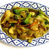 Singaporean Noodles · Stir fried rice noodles with yellow curry, broccoli, carrots and green onions. Served with c...