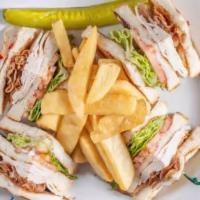 Turkey Club · Triple decker sandwich with oven-roasted turkey, crispy bacon, lettuce and tomatoes with fre...