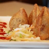Chicken Samosa · Hand rolled pastry stuffed with onion and egg.