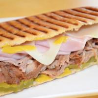 The Cuban Panini · Ham, roast pork, swiss cheese, pickled and yellow mustard. Pressed and served.