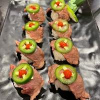 King Miller Roll · Rice with chefs special sauce  topped  with A5 Japanese Wagyu Garnished with a Fresh jalapeñ...