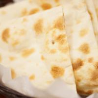 Plain Naan · Flat and soft bread made of white flour and baked in the clay oven. 