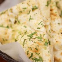 Garlic Naan · Flat and soft bread made of flour, garlic, cilantro, and baked in the clay oven. 