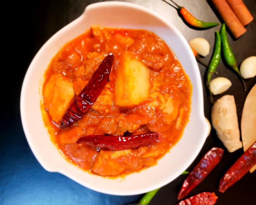 Chicken Vindaloo · Chicken cooked with potatoes and sun-dried kashmiri red-chili in a vindaloo sauce.  Spicy.