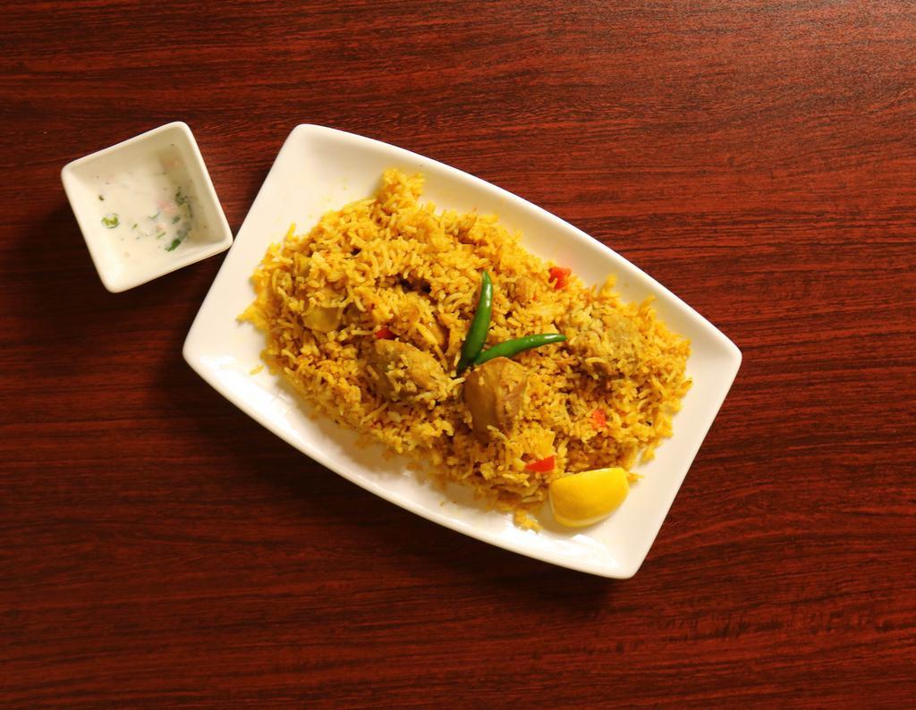 Chicken Biryani · Boneless and juicy chicken layered with basmati rice and flavored with spices. 