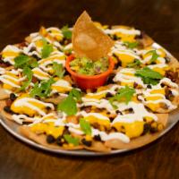 Macho Nachos · Warm corn tortilla chips with chile con queso, pickled jalapenos, black beans, roasted corn,...
