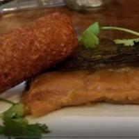 Pasteles · Savory plantain masa stuffed with chicken or pork, onions, garlic and peppers wrapped in a b...