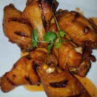 Alitas Fritas · 6 chicken wings seasoned and fried to golden perfection.