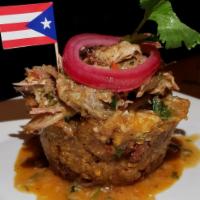 Mofongo · Made from fried green plantains mashed together with garlic and seasonings and choice of top...