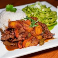 Lomo Saltado · A traditional Peruvian dish, a stir fry that combines marinated strips of sirloin with red o...