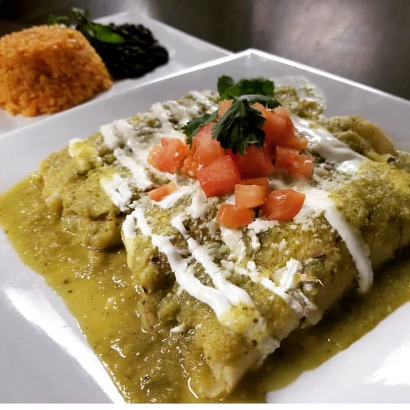 Enchiladas Con Salsa Verde · A traditional Mexican dish, 3 corn tortillas rolled around choice of chicken, vegetables, steak, or shrimp, covered with a green tomatillo sauce, topped with crumbled cotija cheese, pico de gallo and served with yellow rice and corn and a side of black beans