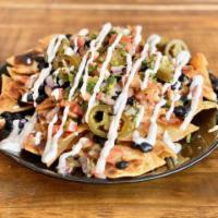 Nachos · melted cheese, pickled jalapeño, pico de gallo, sour cream and black beans