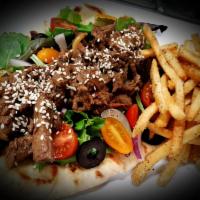 Sirloin Shawarma Wrap · Marinated sirloin fajitas, lettuce, red onions, and tomatoes, wrapped on Naan bread or Thin ...