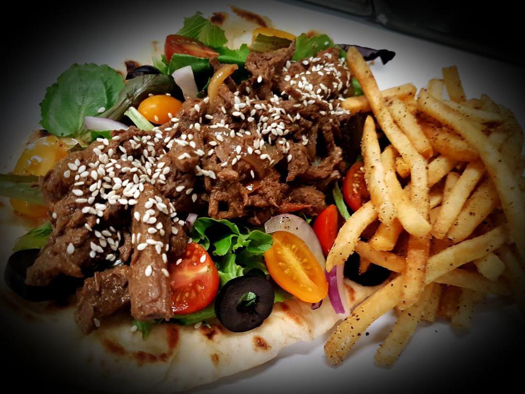 Sirloin Shawarma Wrap · Marinated sirloin fajitas, lettuce, red onions, and tomatoes, wrapped on Naan bread or Thin Lebanese bread, with a side of seasoned fries.