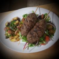Kafta · 2 skewers. Ground beef with fresh herbs and spices, served with salad and a side of harra po...