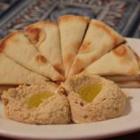 Hummus and Pita · Chickpea and tahini spread served with warm pita triangles.