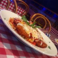 Parmigiana · Breaded cutlet topped with marinara sauce and mozzarella. Served with pasta or house salad.