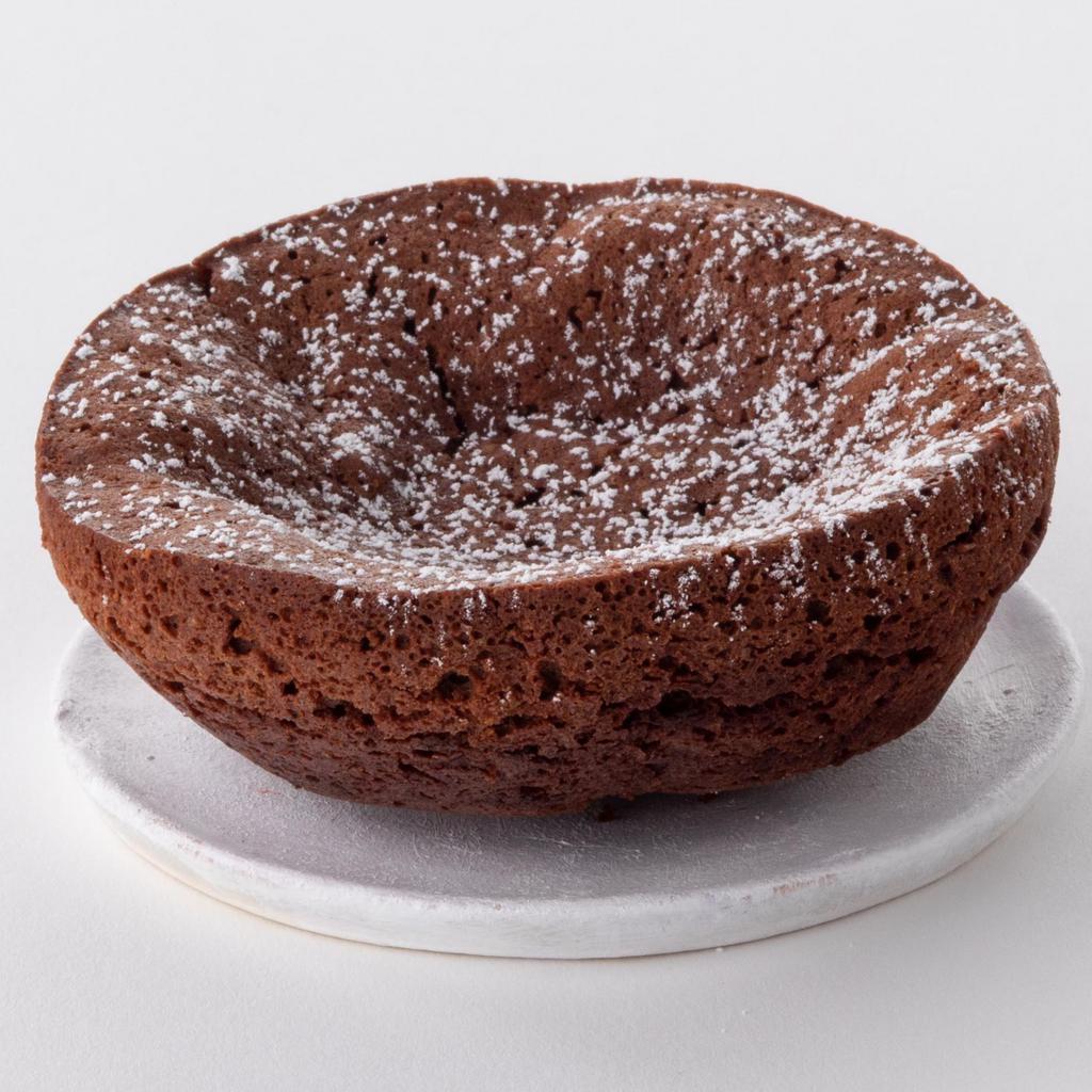 Mini Flourless Cake to go · A dense, rich fudgy chocolate cake or cupcake made without flour.  Whipped egg whites give this cake its structure. The pan is coated with cocoa powder to keep it flourless.

(Sold individually)