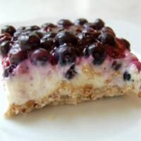 Blueberry Jamboree Bar to go · Pecan shortbread crust layered with a cream cheese and whipped cream filling. With a fresh b...