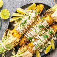 Elote · Seasoned grilled corn with Cotija cheese.