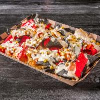 Tex-Mex Nachos · Corn tortilla chips topped with onions, tomatoes, jalapenos & roasted corn smothered in ques...