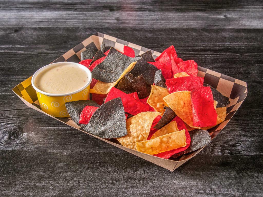 Chips N' Queso · Warm corn tortilla chips served with fresh made creamy queso