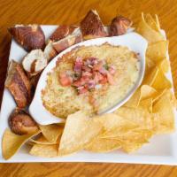 Jalapeno Popper Dip · Topped with pico de gallo served with warm pretzels and corn tortilla chips.