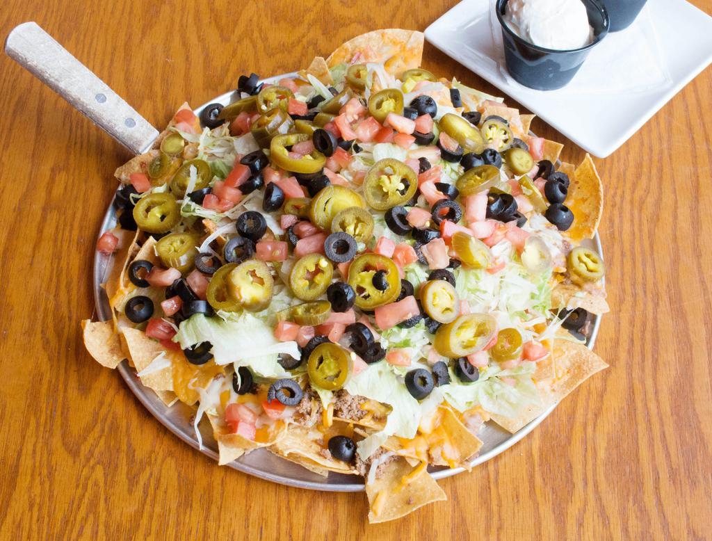Pub Nachos · Corn tortilla chips topped wI think Mexico cheese mix, jalapenos, black
Beans, lettuce, Pico de gallo served with salsa and sour cream.
