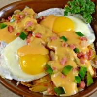 Denver Skillet · Hash browns topped with 2 eggs, with diced grilled ham, onion and green pepper, topped with ...