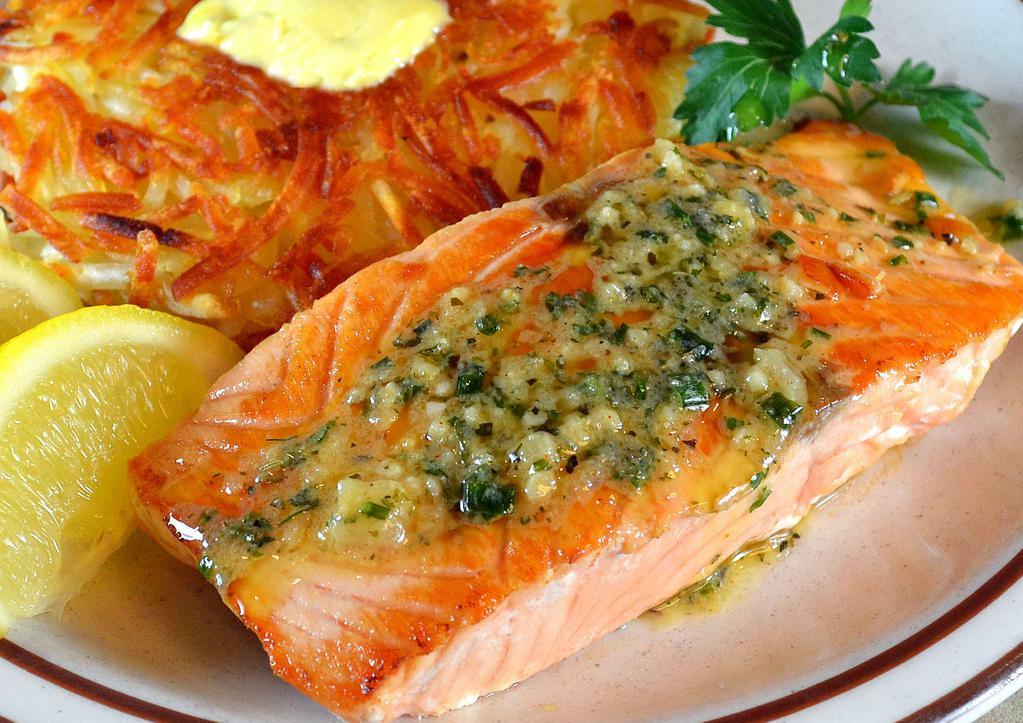 Grilled Salmon · Grilled salmon steak topped with herb garlic sauce.