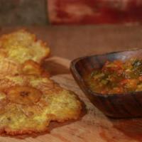 Arepitas con Hogao · Mini corn cakes with tomatoes and scallions sauce.