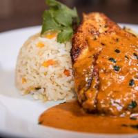 Smokey Cream Pollo · Marinated tender chicken breast, homemade poblano rice and roasted veggies topped off with c...