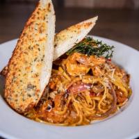 Pasta ai Gamberetti · Linguini pasta, diced tomatoes and green bell pepper in a chipotle sauce. Topped off with sh...