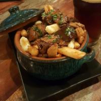 Steak Poutine · Tender succulent beef served over shamrock fries and smothered with a brown herbed gravy top...