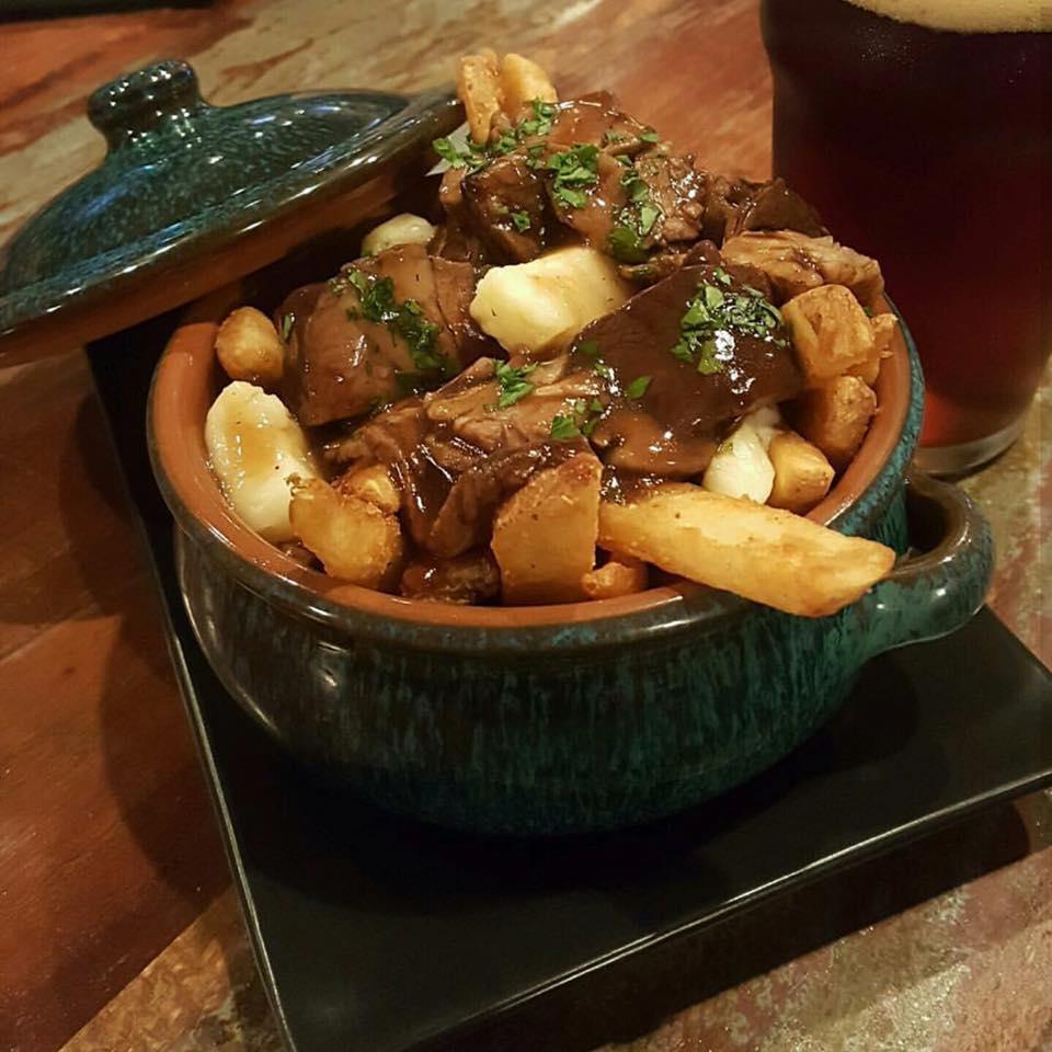 Steak Poutine · Tender succulent beef served over shamrock fries and smothered with a brown herbed gravy topped with cheese curds.