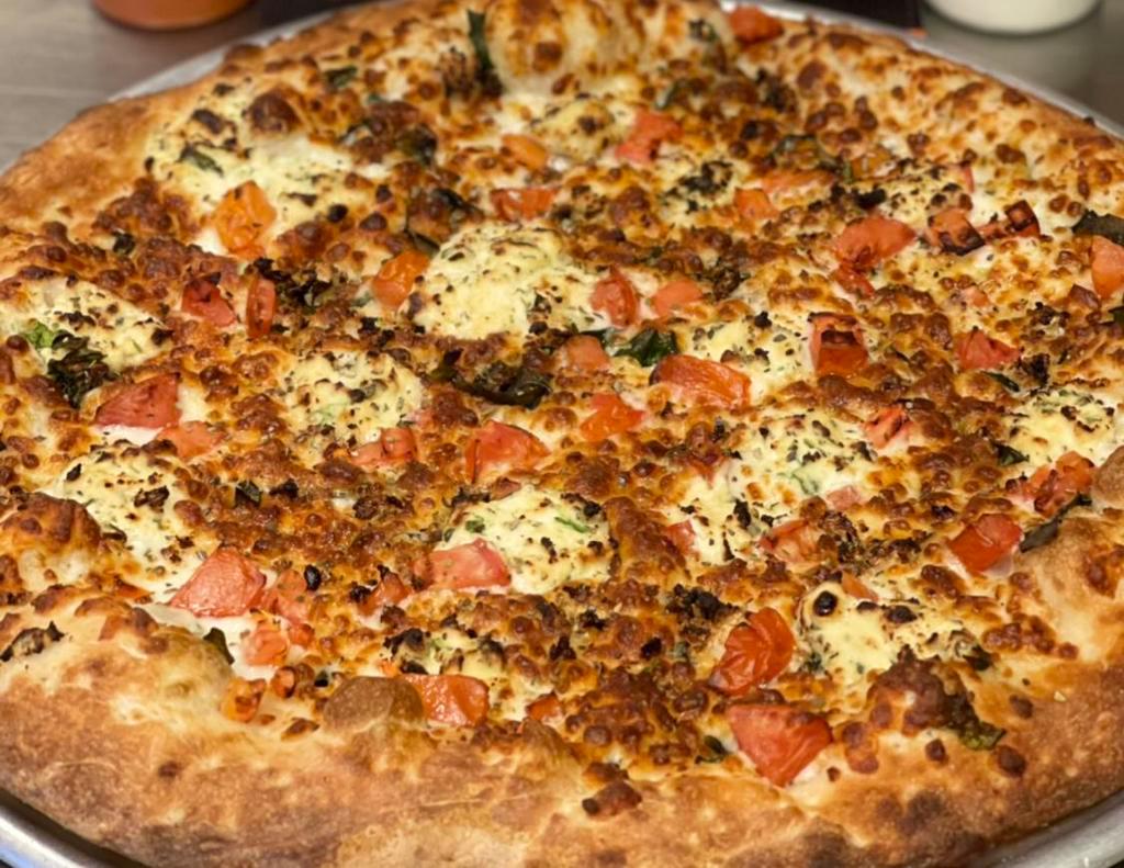 White Pizza  · Tomato, garlic, olive oil, basil, ricotta cheese and mozzarella cheese.  