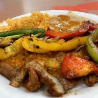 Fajita plate · Shrimp, chicken or beef with bell peppers & onions. Comes with a side of rice and beans.