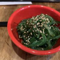 Seaweed Salad · Japanese seasoned seaweed salad with sesame seeds on top.
