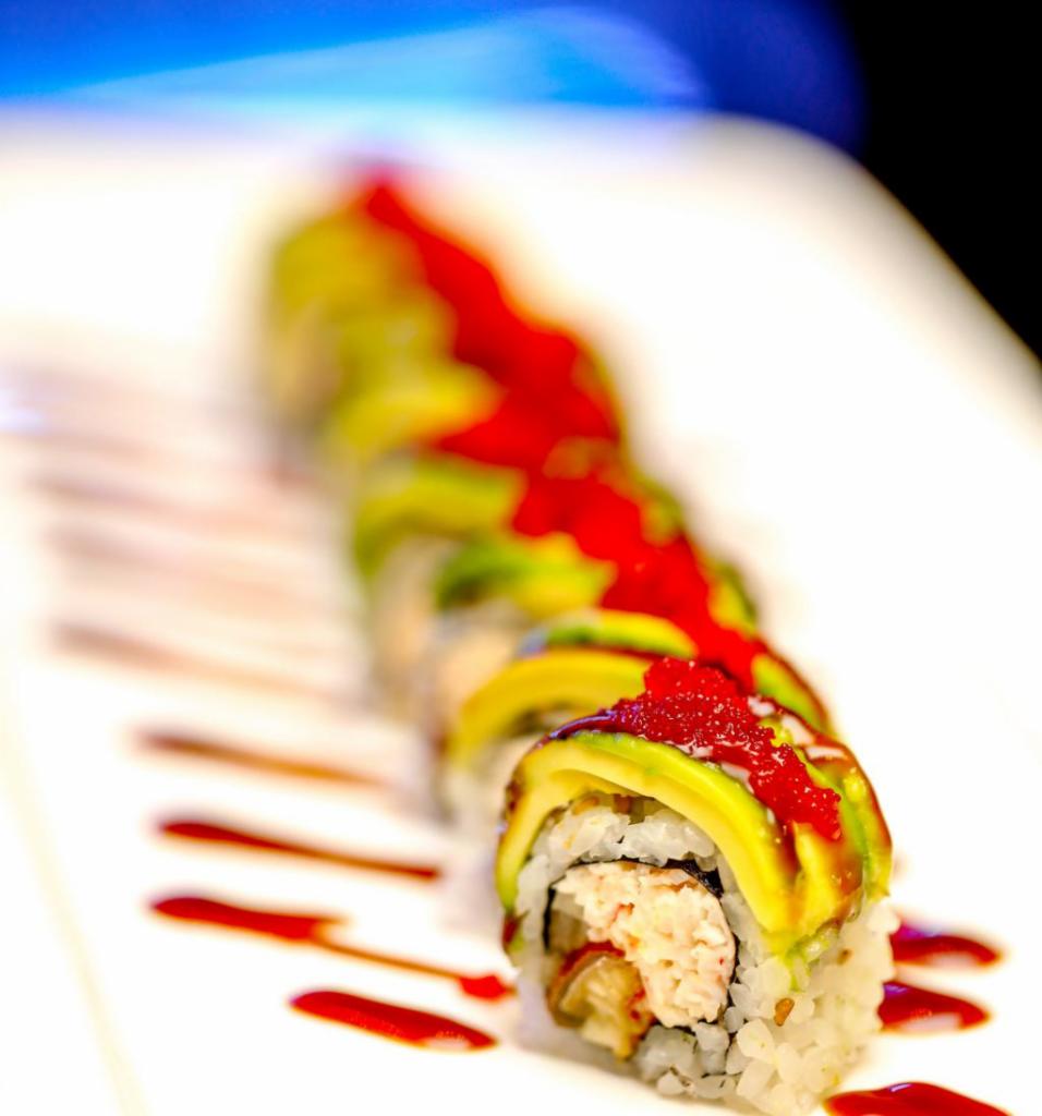 DRAGON ROLL · Eel and cucumber topped with avocado , tobiko , and eel sauce.