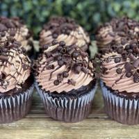 Death by Chocolate Cupcakes · Rich chocolate cake dipped in chocolate ganache and frosted in milk chocolate buttercream.