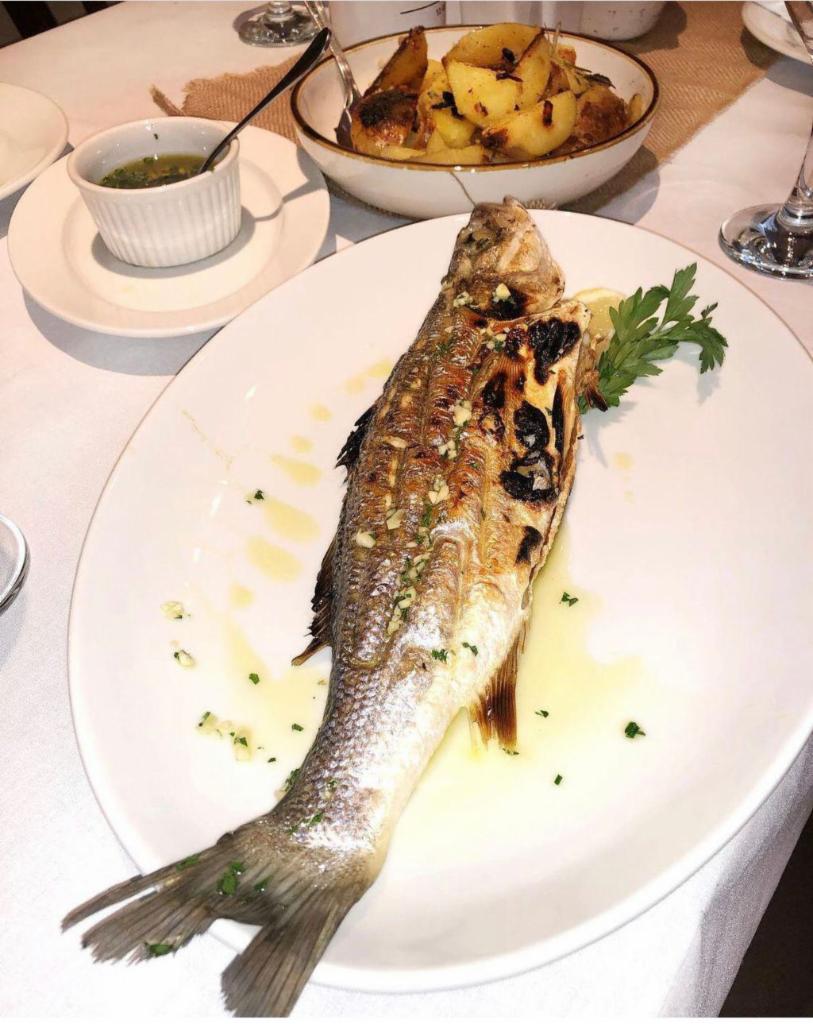 Branzino · Perfectly grilled whole branzino with olive oil and garlic dressing.